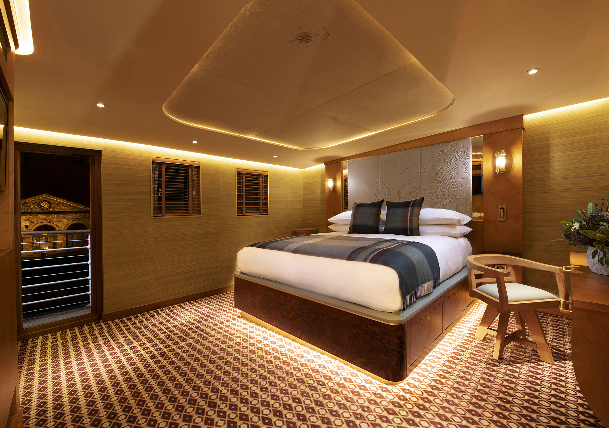 Bedroom picture on board Fingal Hotel. Lights are glowing warm yellow and it's a relaxing atmosphere.